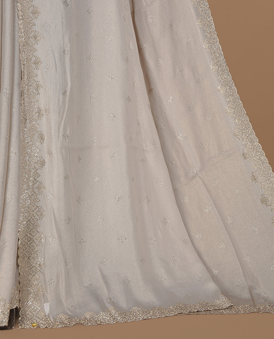 Off white colour organza designer saree featuring Gold stone motifs on body, highlighting light weight stone worked border, paired with matching blouse piece.
