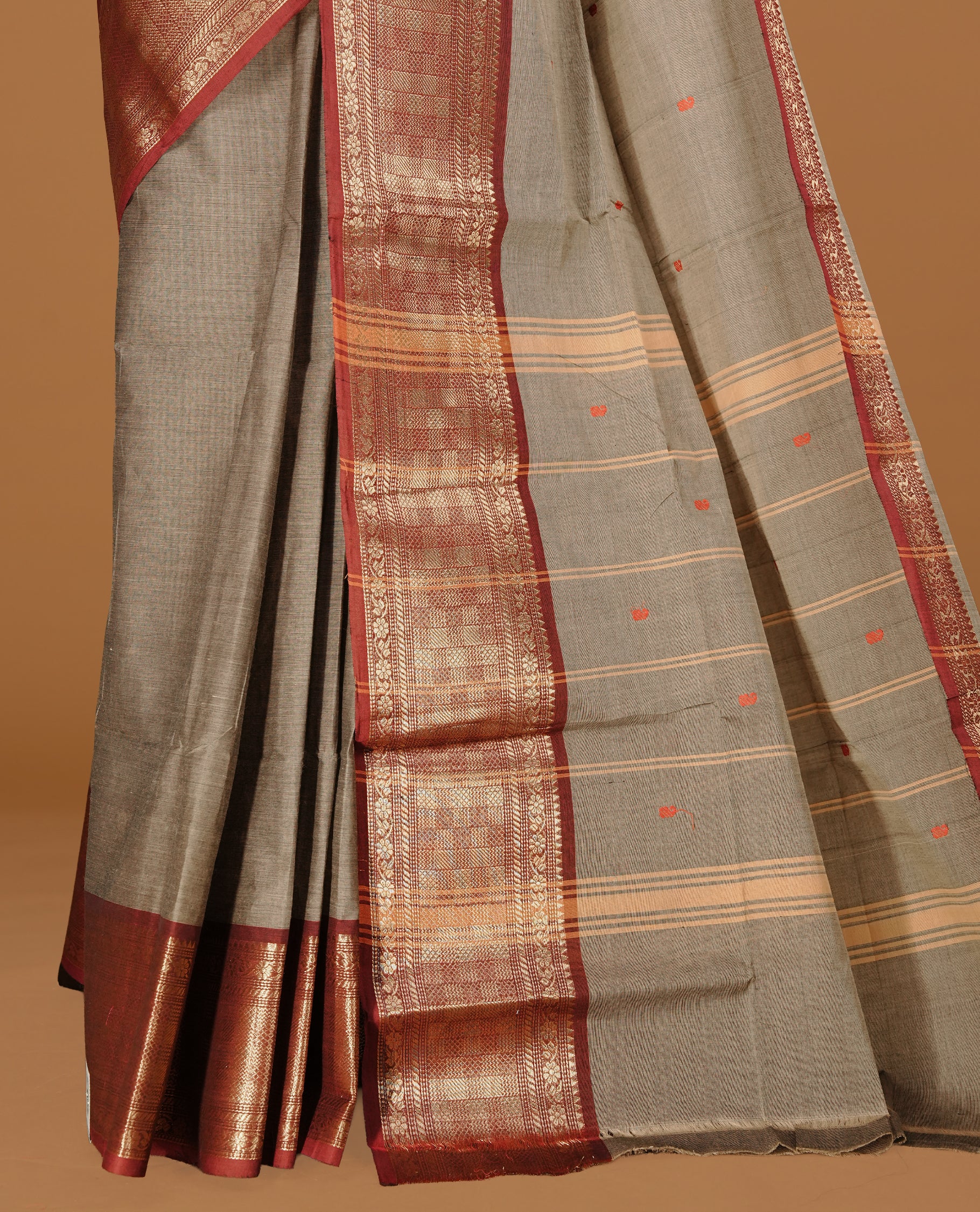 Grey colour Chettinad cotton saree featuring motifs on body , complemented by contrast Maroon colour with zari border, comes with matching blouse piece.