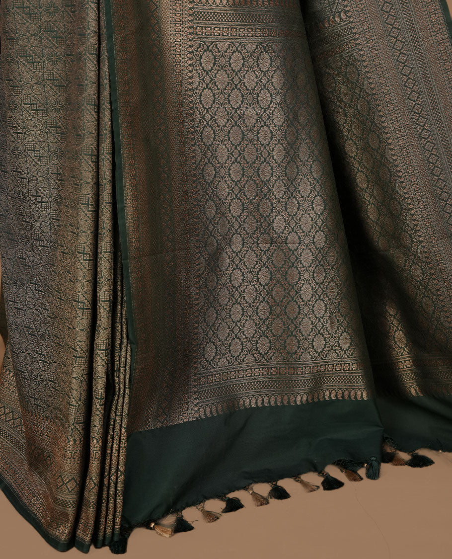 Green colour semi banaras katan saree featuring Gold zari Pattern across body, complemented by self colour with zari border, paired with matching blouse piece.
