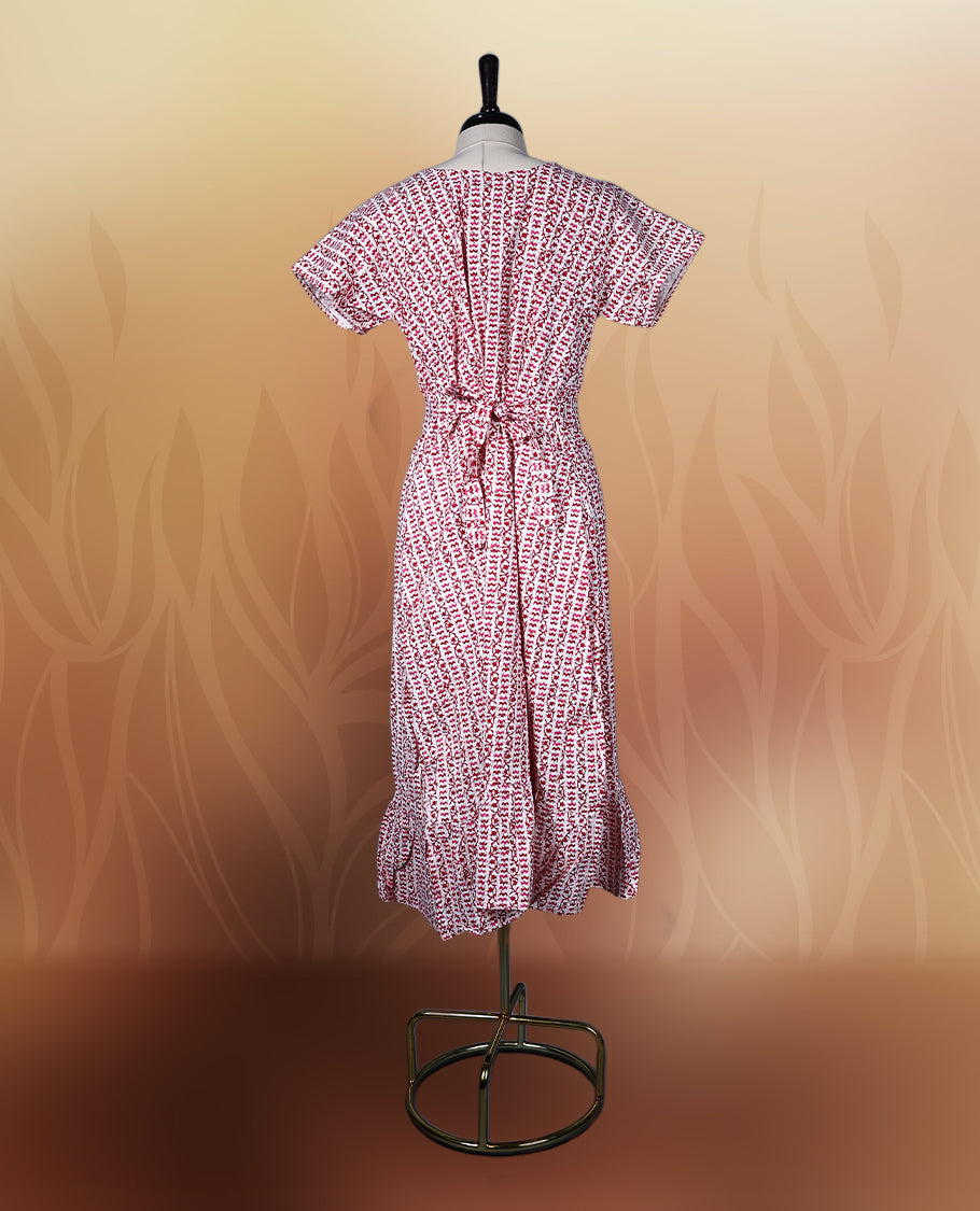Off white colour kurthi with red and peach colour block style prints, V neckline, and short sleeves, Designed with a flattering silhouette and ruffled hem, perfect for everyday comfort and stylish casual wear.