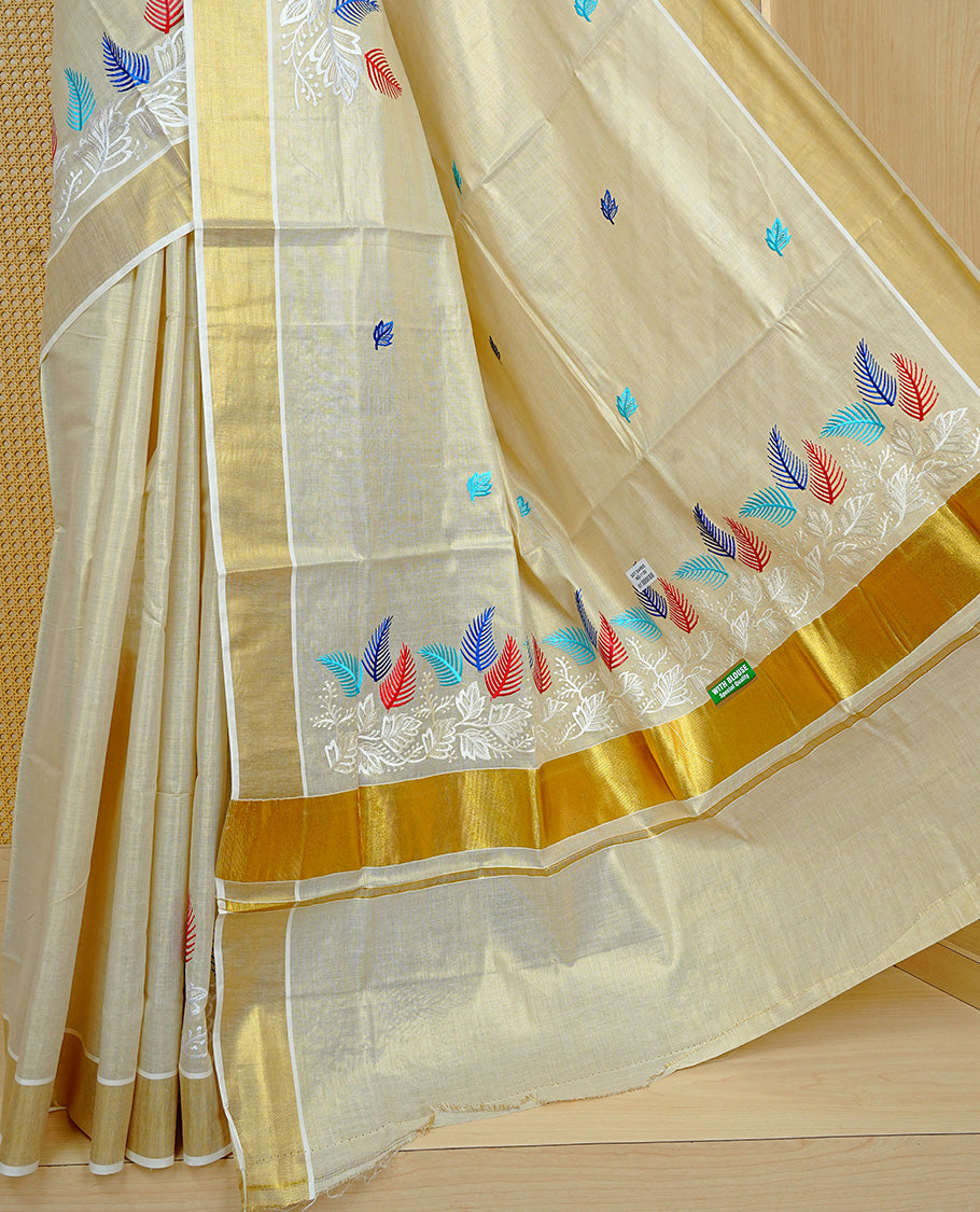 Cream colour Tissue kerala saree featuring Embroidery buttas on body, complemented by Leaf thread work & kasavu kara, comes with matching blouse piece.