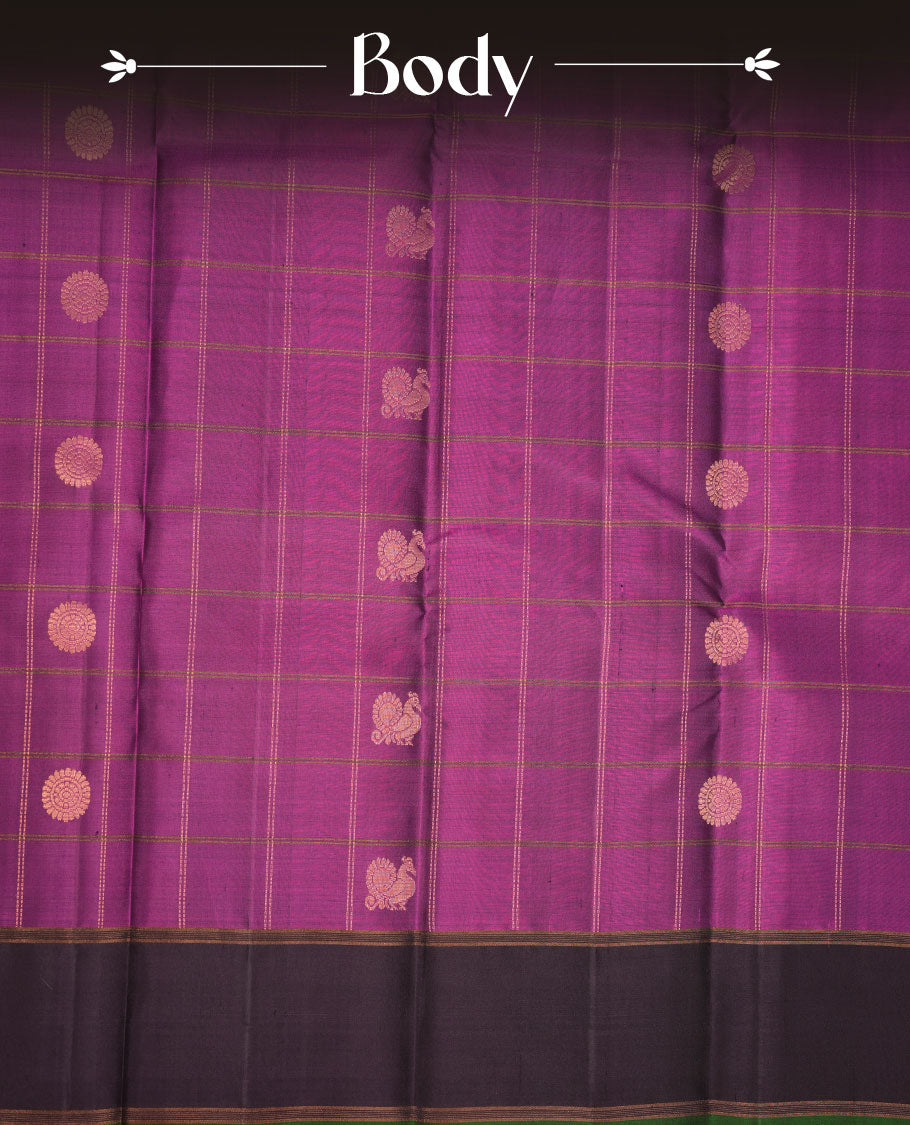 Burgundy colour soft silk saree featuring elegant gold zari check across the body, complemented by a contrast deep purple with green piping on border, and paired with a matching blouse piece.