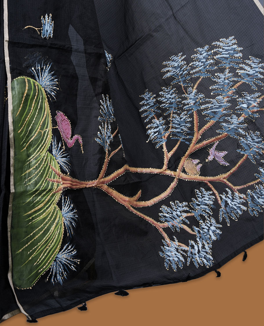 Black colour semi tusser silk saree featuring refined floral embroidery across the body, enhanced with gentle contrast border detailing and accompanied by a perfectly matching embroidered blouse.