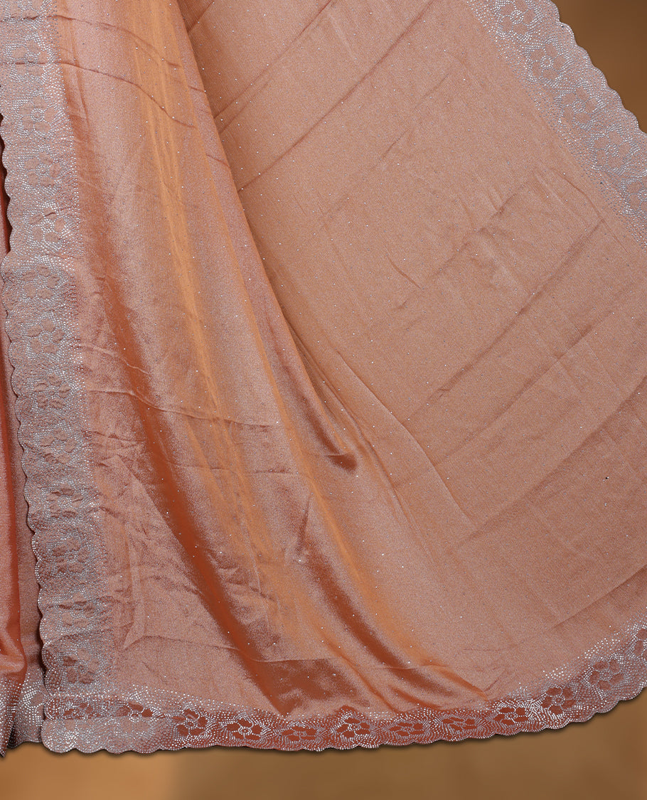 Peach colour shimmer designer saree, featuring a stone motifs on body, with  heavy stone patttern on border and  pallu, Paired with matching blouse.