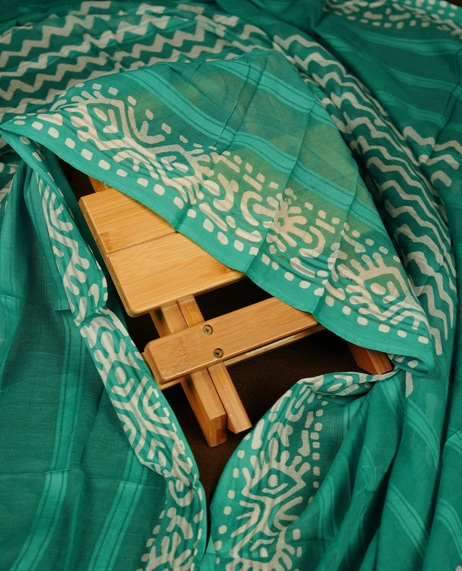 Persian Green colour churidar material featuring white floral printed body, paired with a matching chevron printed dupatta.