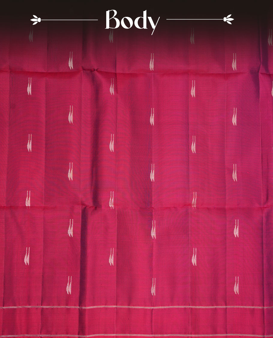 Burgundy colour soft silk saree featuring gold zari motifs on body, complemented by self colour with traditional border with tassel at pallu, paired with matching blouse piece.
