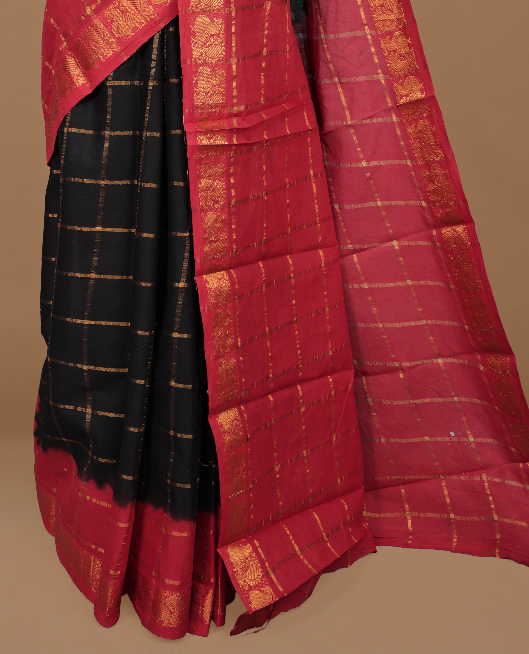 Black colour Sungudi cotton saree featuring Gold zari Check pattern on body, Gold zari Peacock design on Dyed Red colour design border, paired with matching blouse piece.