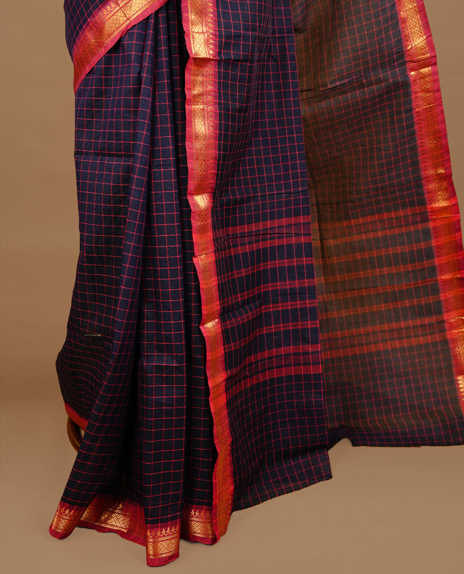 Dark blue colour chettinad cotton saree featuring  Check pattern  on body, complemented by magenta colour with zari border, paired with matching blouse piece.
