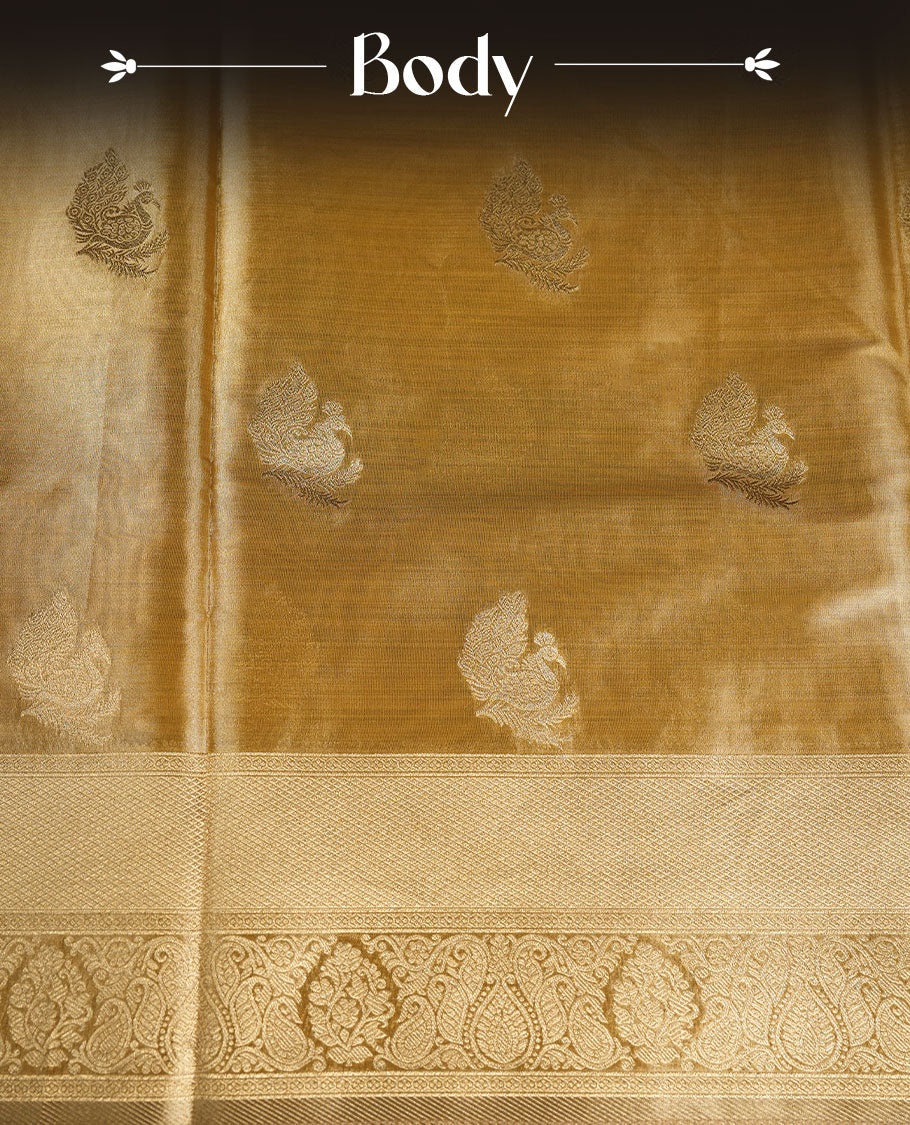 Gold colour tissue brocade saree featuring all-over zari floral motifs on the body, a rich traditional zari border and an intricately woven pallu, paired with a matching blouse piece.