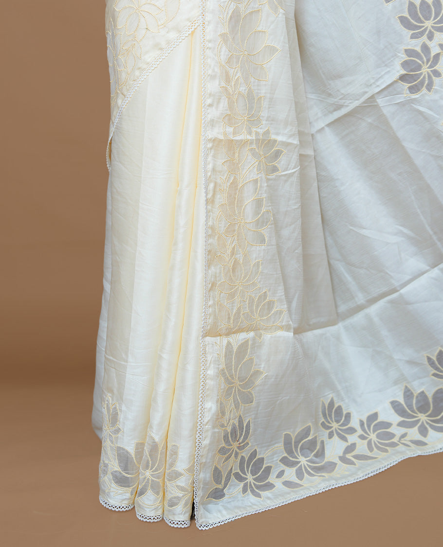 White colour Designer saree Featuring Elegant plain body, enhance with thread Lotus Pattern with lace border, paired with matching blouse piece.