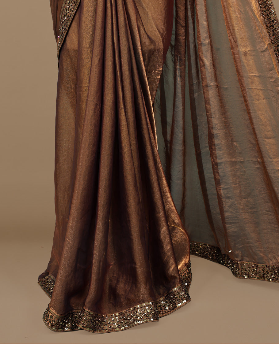Gold & brown double shade designer saree features Elegant plain body, highlights Sequins & cut beats on border, paired with ready made blouse.