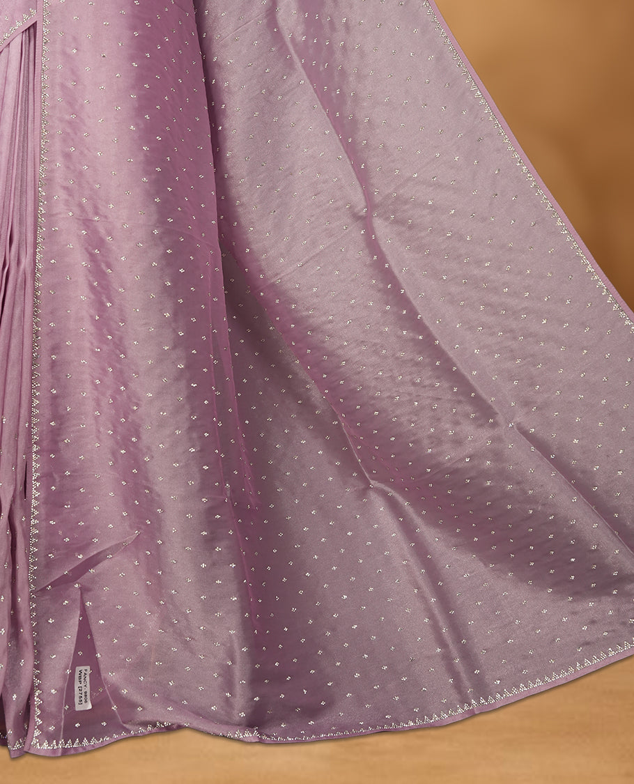 Light Purple Colour net shimmer fancy saree adorned with white stone buttas all over the body, paired with a delicate stone worked border and matching blouse
