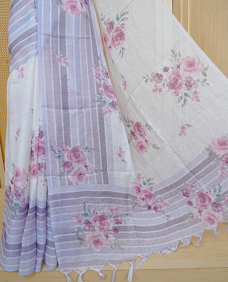 Cream colour semi linen saree featuring Pink colour floral print on body, complemented by contrast Strip pattern border, comes with matching blouse piece.