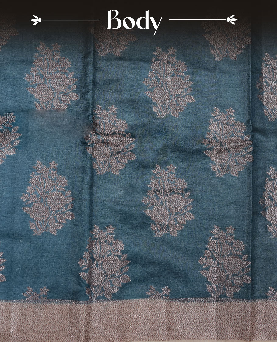 Teal colour pure banaras tusser silk saree highlighting antique zari pattern across body, with contrast cream colour with zari border and paired with matching blouse