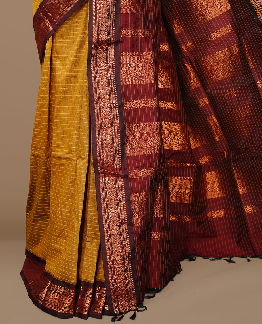 Mustard colour kalyani cotton saree featuring gold zari check pattern on body, complemented by Maroon colour with Antique zari border, paired with matching blouse piece.