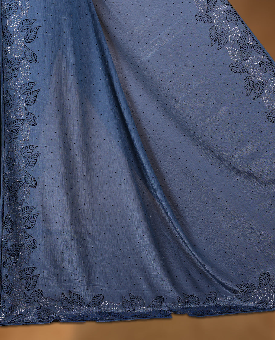 Ash blue colour chiffon designer saree, featuring black and white scattered stone on body, stone work and heavy stone leaf pattern on border and  pallu, Paired with matching blouse.