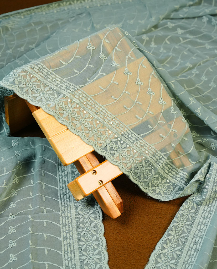 Soft Green colour Churidhar Material featuring Intricate Thread Embroidery with Mirror and Cut Beads Work on the Front Panel, paired with an All Over Embroidered Net Dupatta and Matching Bottom