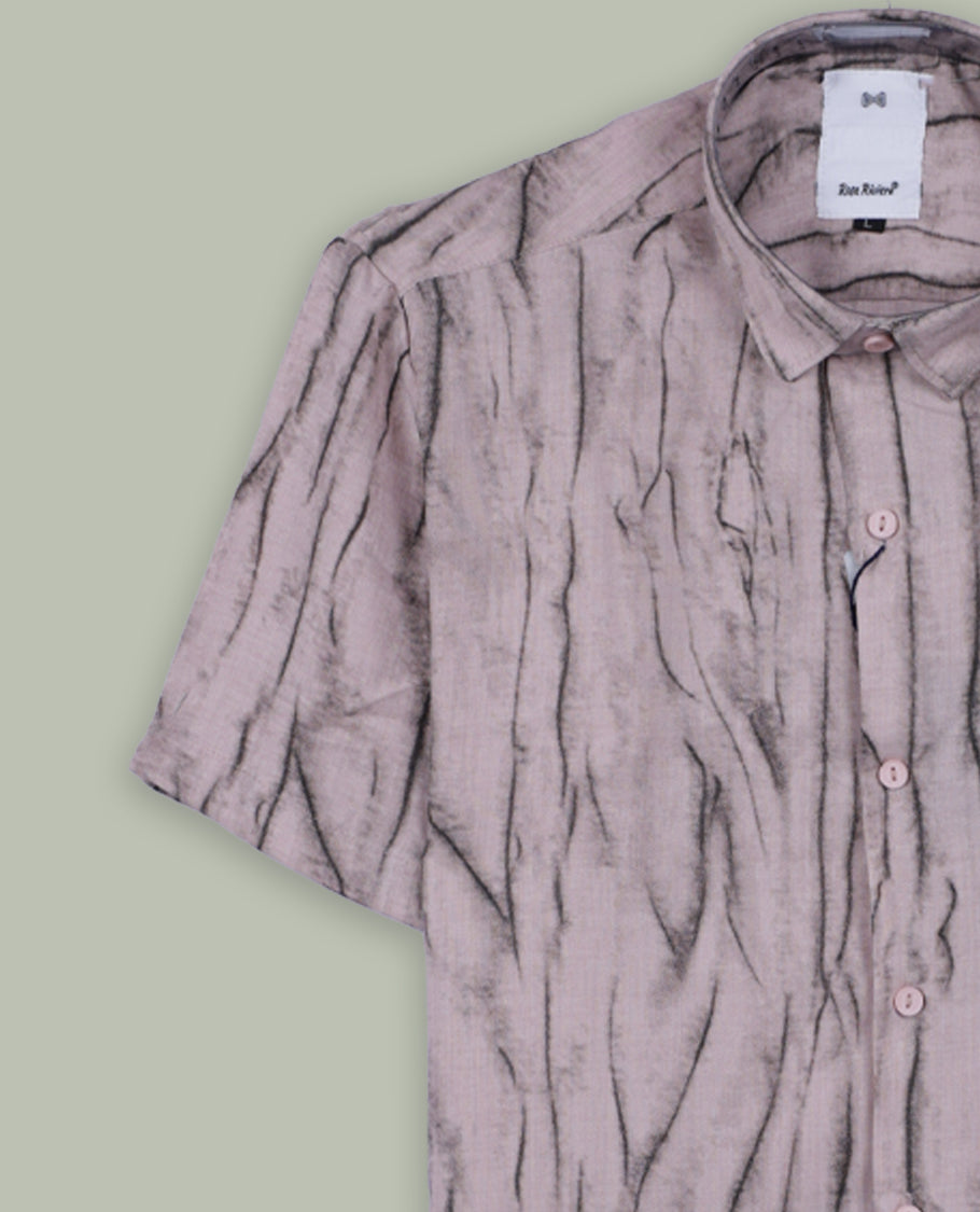 Light mauve short sleeve shirt featuring a unique crinkled black linear pattern, button down front, and classic collar & Crafted from breathable fabric, perfect for a casual yet stylish everyday look.