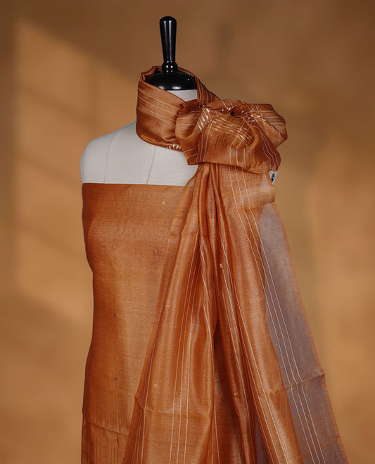 Mustard shade Tussar suit material with elegant thread detailing on the body, paired with a plain bottom and a worked Tussar dupatta.