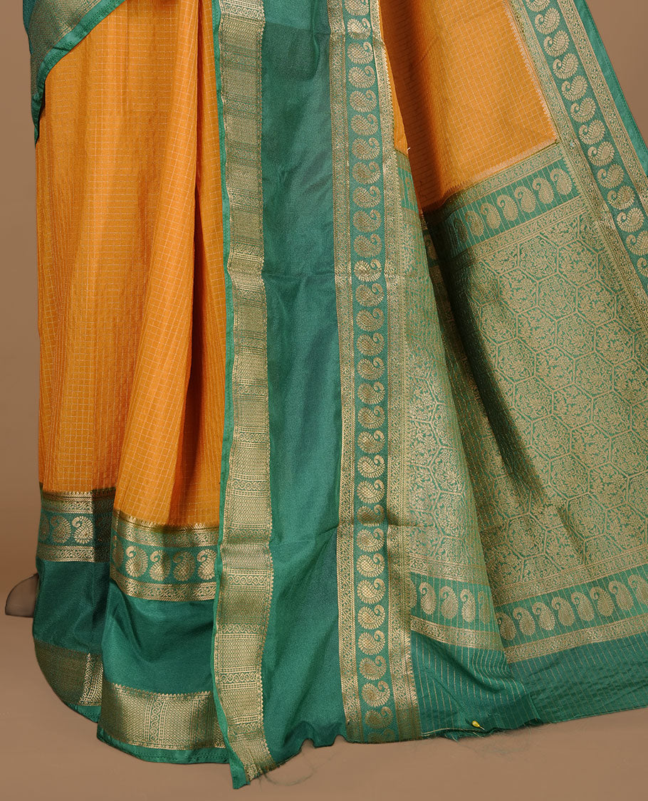 Mustard colour semi georgette saree featuring gold zari check pattern on body, complemented by contrast green colour with zari border, paired with matching blouse piece.