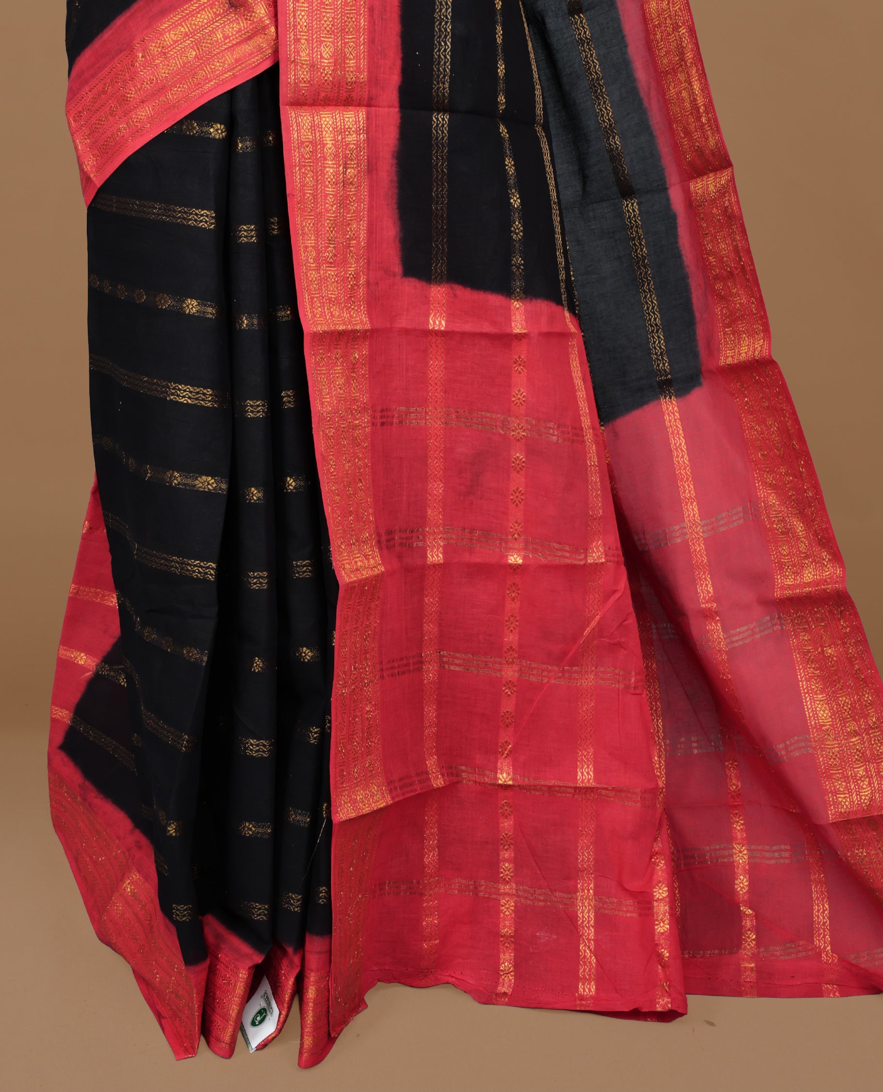 Black colour Sungudi cotton saree featuring Gold zari Stripes on body, Gold zari on Contrast red colour border, paired with matching blouse piece.