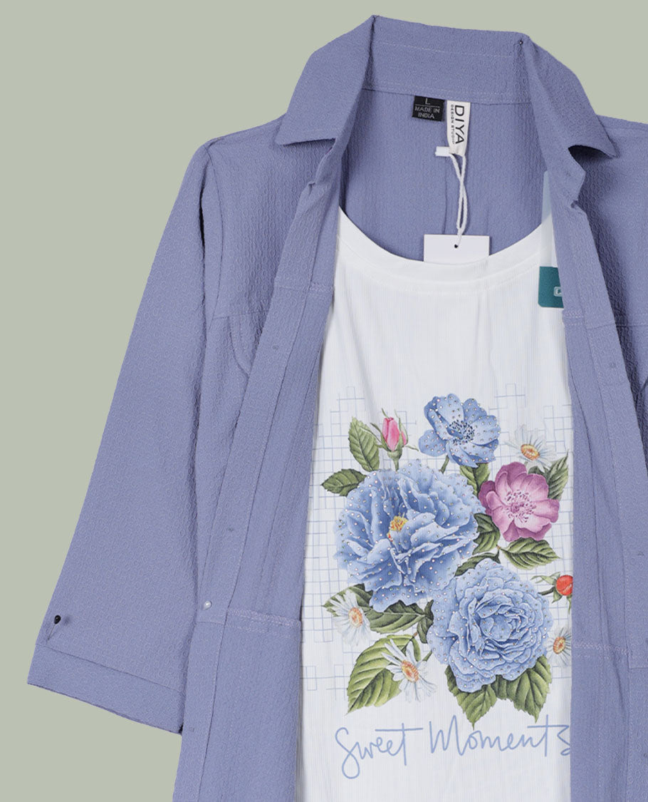 Periwinkle blue open-front shrug with collared neckline and three-quarter sleeves, layered over a white floral graphic tank top.