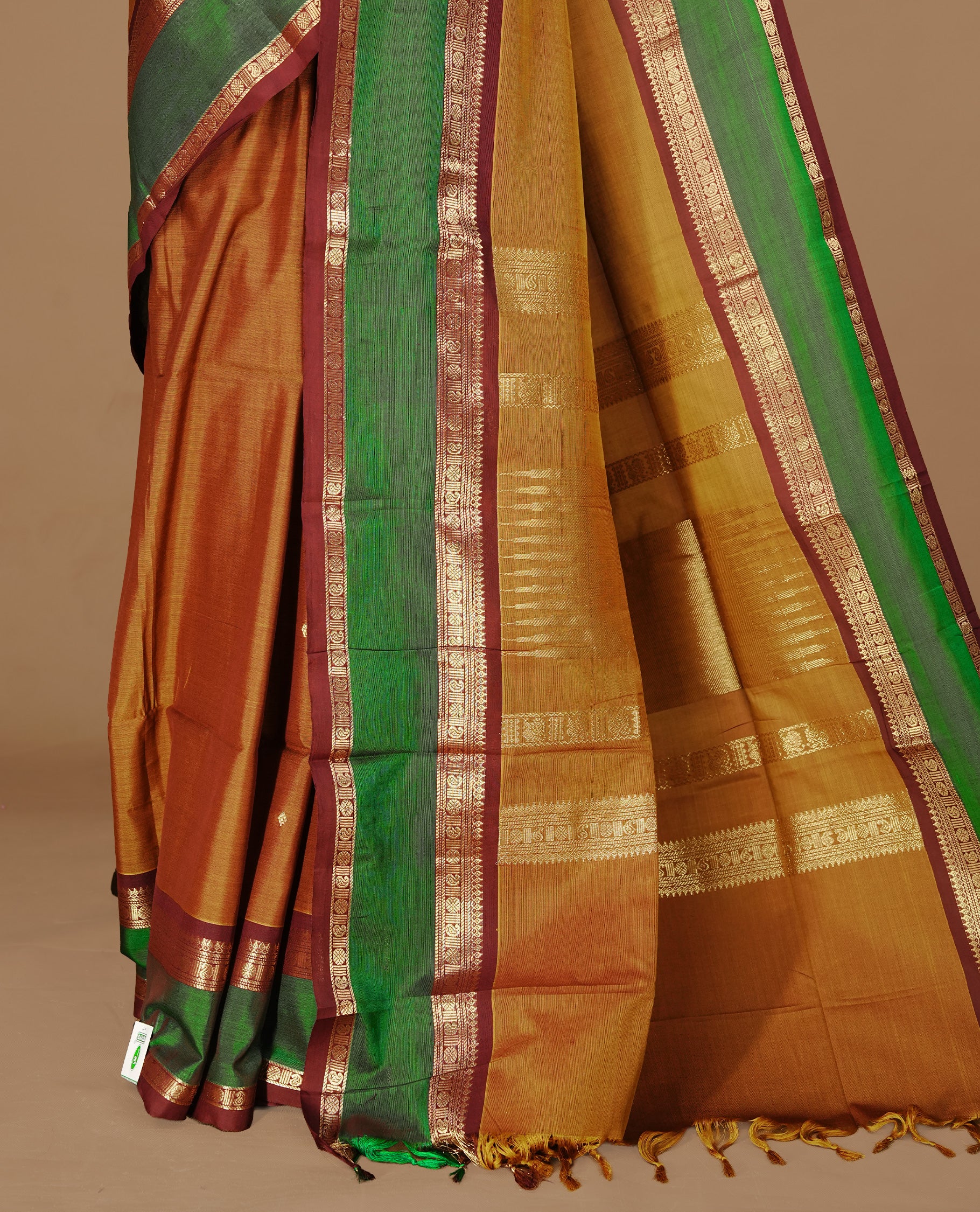 Mustard Olive Colour Chettinad cotton saree featuring Gold zari motifs on body , complemented by contrast Chocolate & Green colour with traditional border, comes with matching blouse piece.