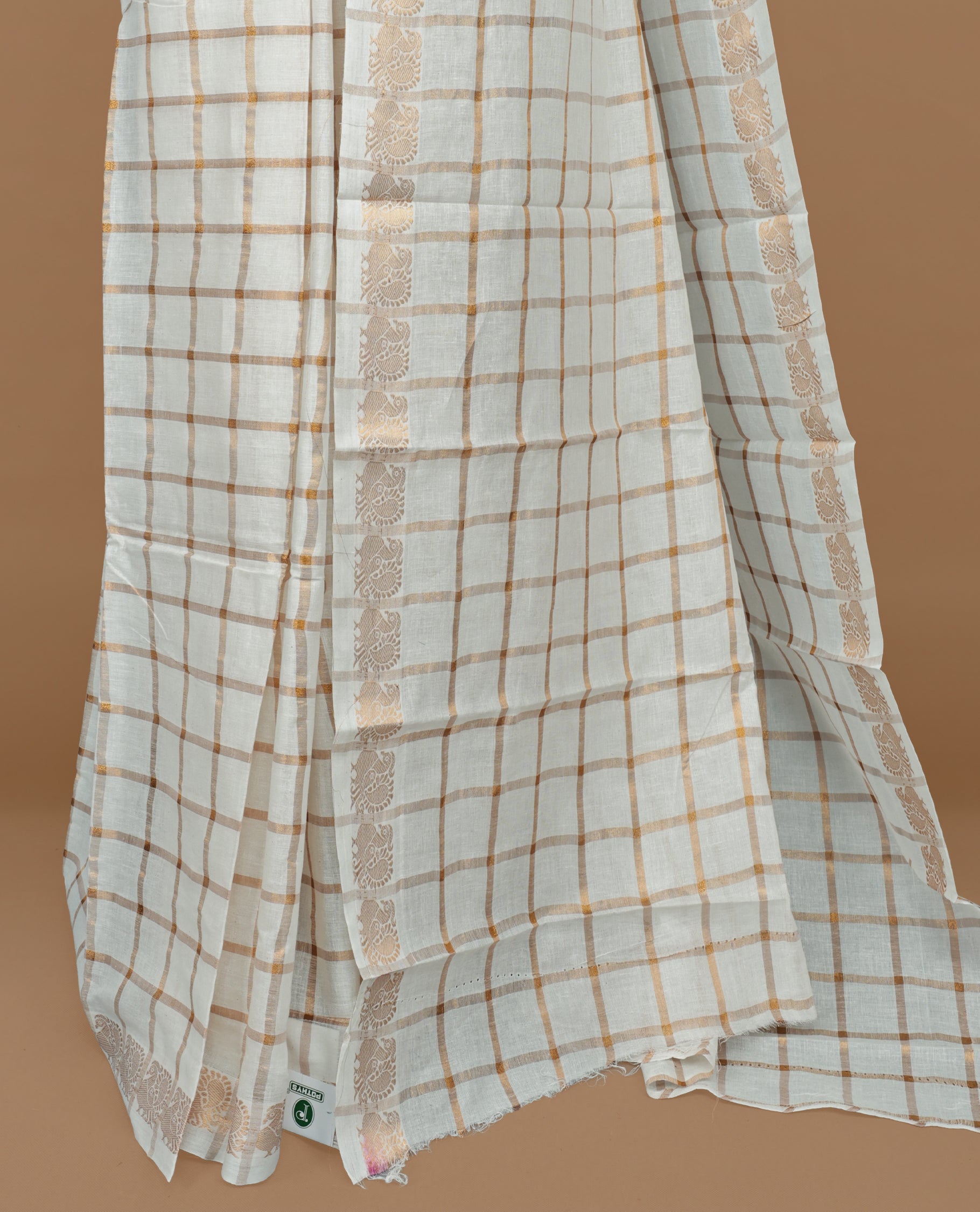 Off white colour Sungudi cotton saree featuring Gold zari checks on body, Gold zari Peacock design on Self colour border, paired with matching blouse piece.