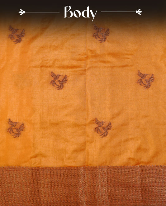 Mustard colour semi banaras tussar silk saree highlighting gold zari bird motifs on body, complemented by self colour with antique zari border, paired with matching blouse piece.