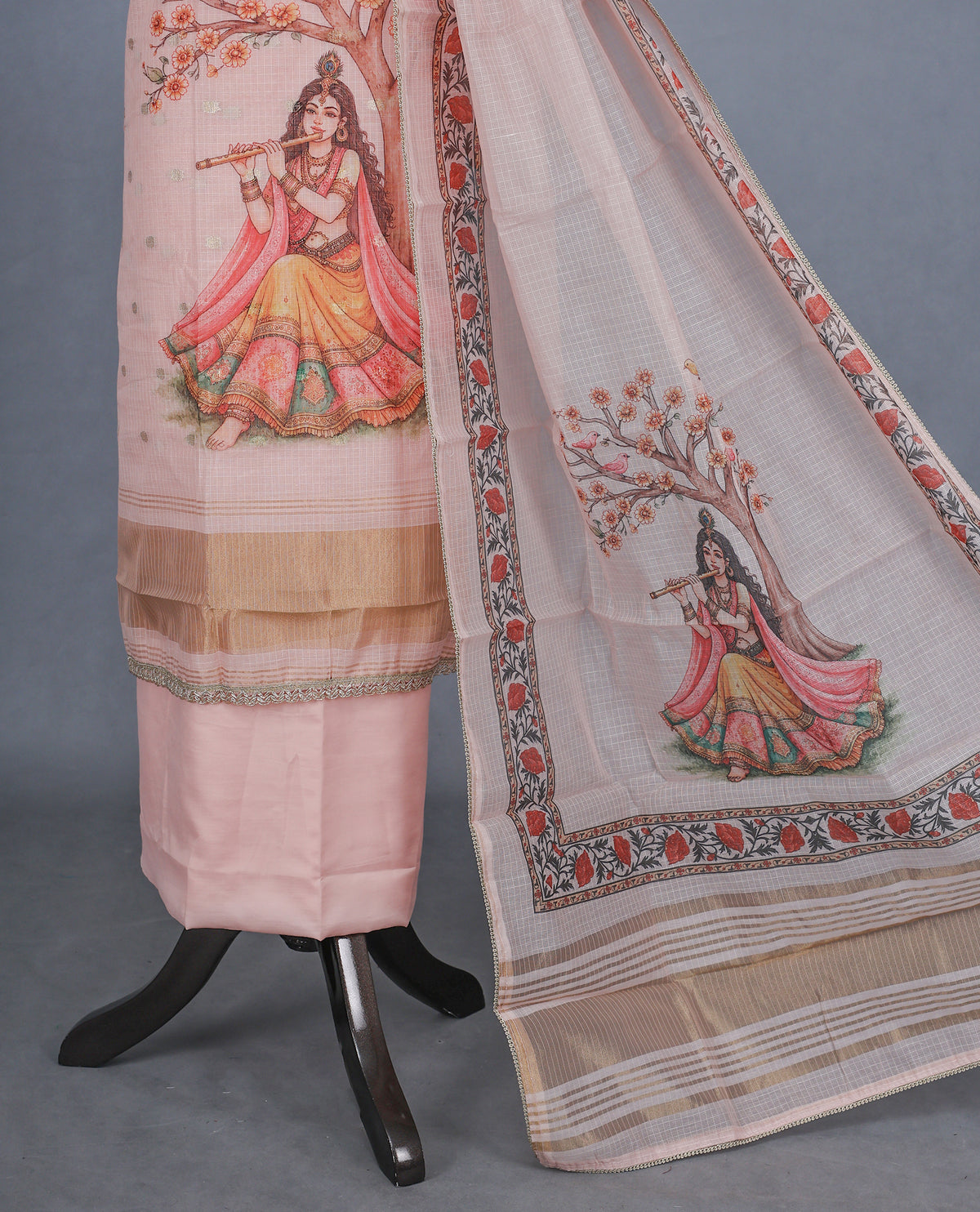 Light pink Colour Kotta Net Salwar material featuring a beautiful Radha inspired digital print with floral motifs and subtle golden accents on body , paired with a matching bottom and dupatta.
