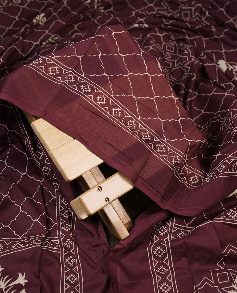 Wine colour churidar material featuring delicate thread embroidery with mirror work on the front panel, paired with a printed dupatta and matching bottom.