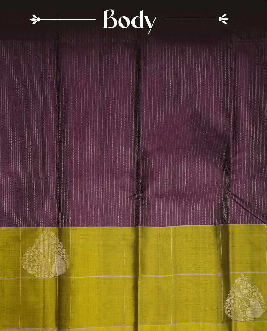 Jamun fruit colour soft silk saree featuring rain drop stripes on body, complemented by contrast henna green with peacock buttas border, paired with matching blouse piece.