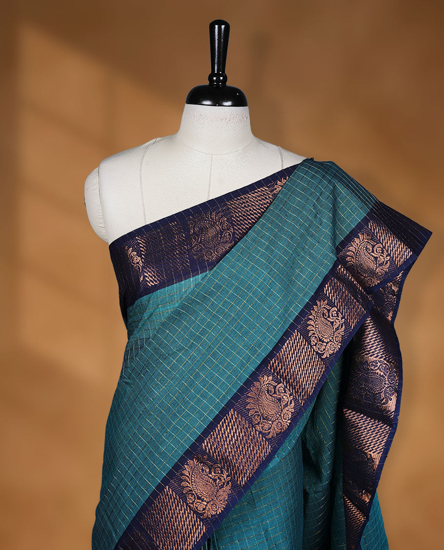 Teal colour sungudi cotton saree featuring gold zari check pattern across body, contrast Dark blue colour with gold zari pattern on border, without blouse piece.