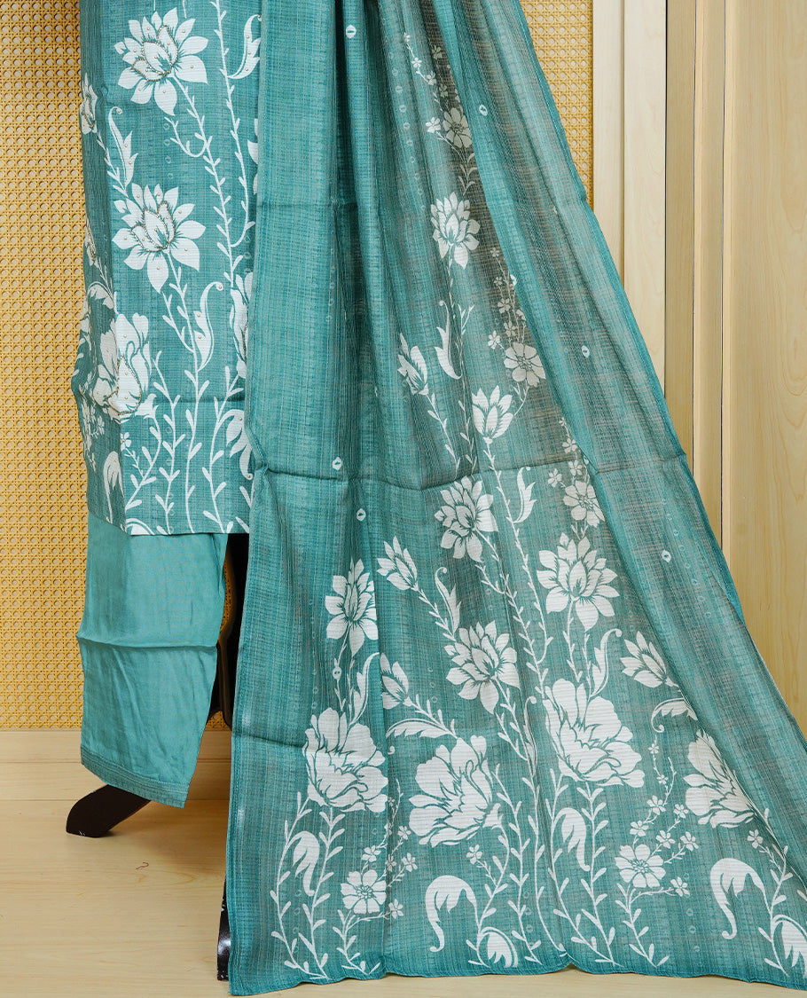 Teal green colour churidar set with floral prints and mirror embellishments on the V-neckline, paired with a matching printed dupatta and solid pants.