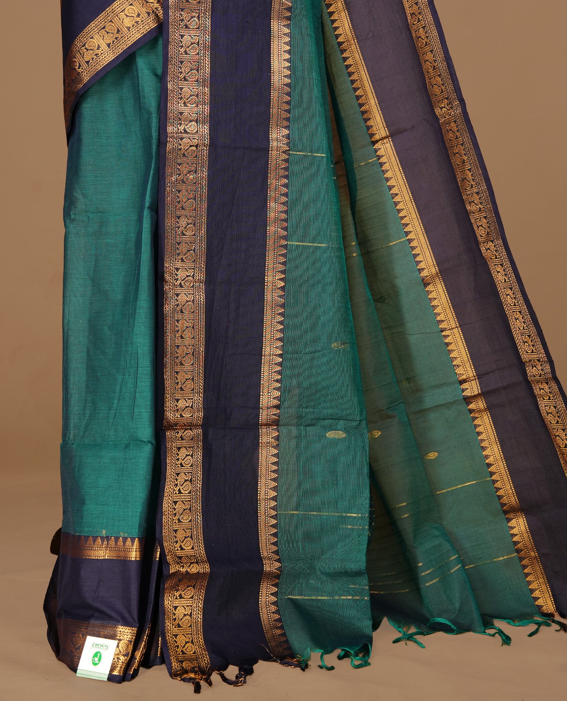 Teal green Colour Chettinad cotton saree featuring Gold zari motifs on body , complemented by contrast blue colour with traditional border, comes with matching blouse piece.