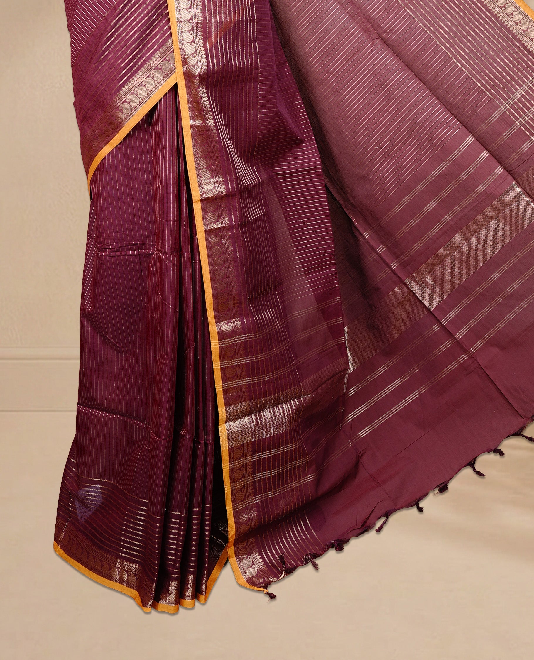 Maroon colour Chettinad cotton saree featuring Gold zari stripes on body, complemented by Self colour with Gold zari border mustard piping, paired with matching blouse piece.