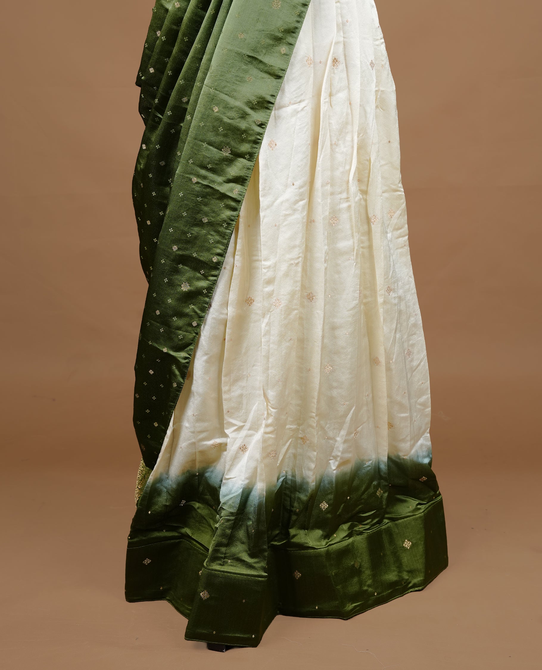 Off White colour half saree material featuring delicate zari buttas on the blouse and skirt, paired with a contrast Green zari border and matching small zari motifs dupatta
