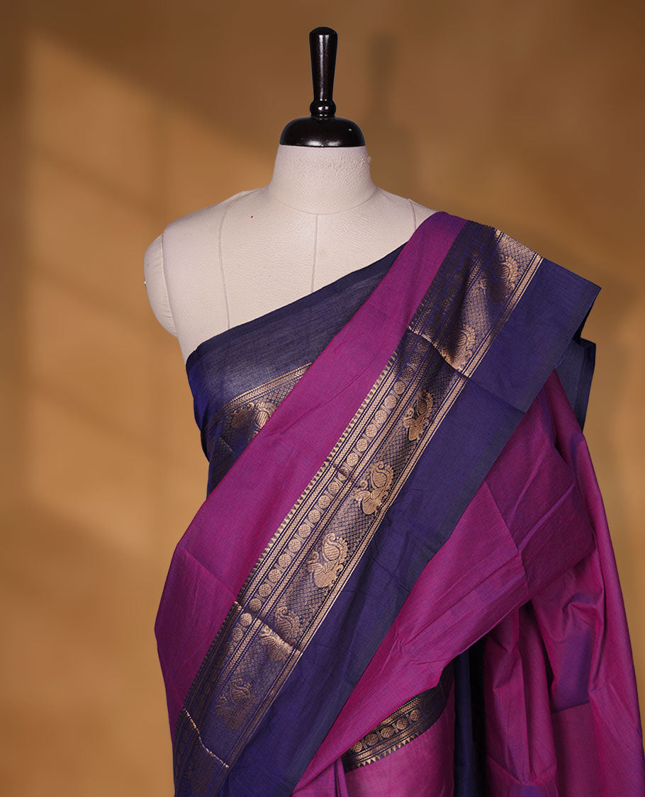 Purple colour chettinad cotton saree featuring plain body, contrast Navy blue colour with traditional gold zari border without blouse.