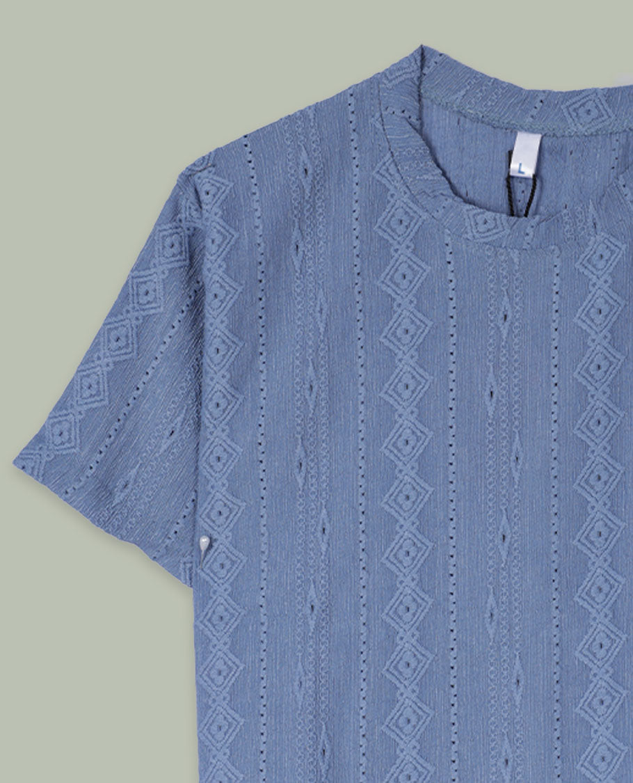 Dusty blue textured short-sleeve top with round neckline and subtle vertical geometric jacquard pattern all over.