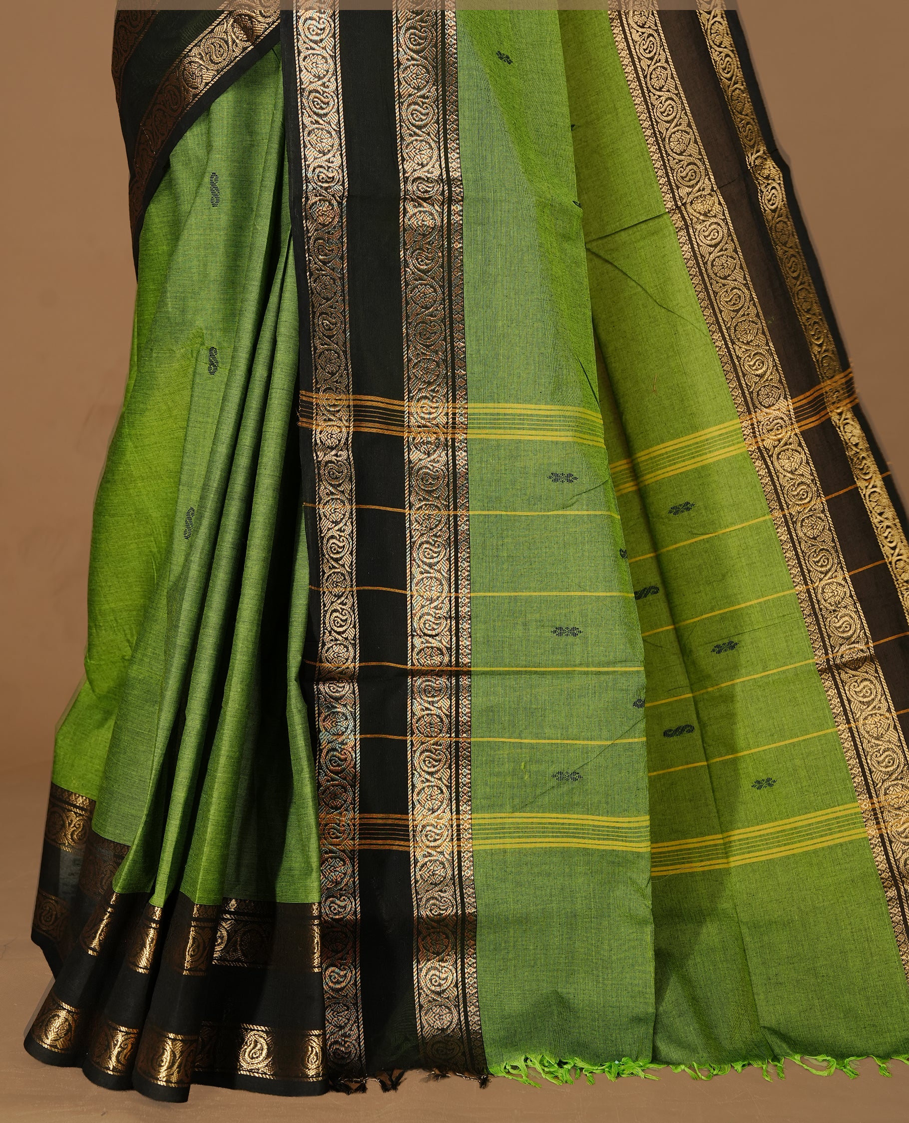 Green colour Chettinad cotton saree featuring motifs on body , complemented by contrast Black colour with zari border, comes with matching blouse piece.