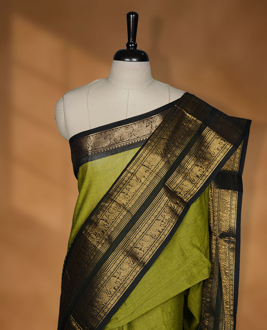 Lemon green colour chettinad cotton saree featuring plain body, contrast black colour with traditional gold zari border without blouse.