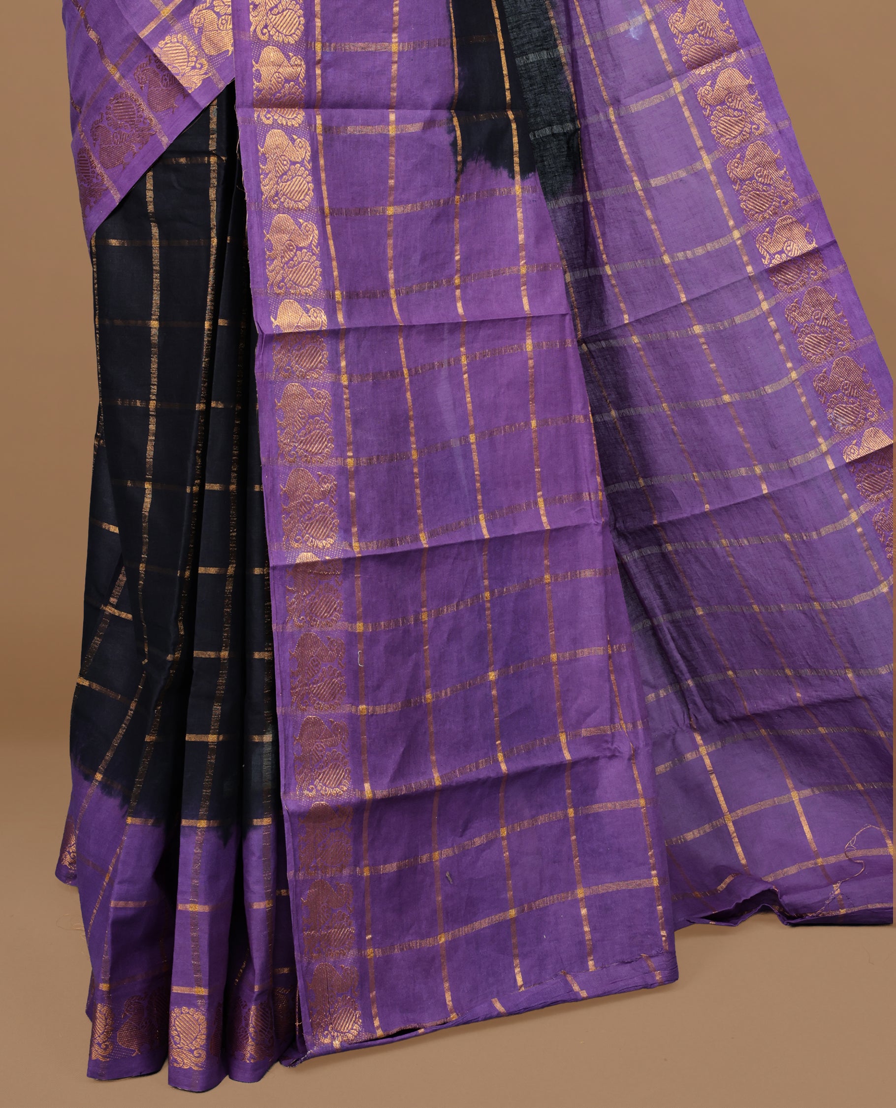 Black colour Sungudi cotton saree featuring Gold zari Check pattern on body, Gold zari Peacock design on Dyed Violet colour design border, paired with matching blouse piece.