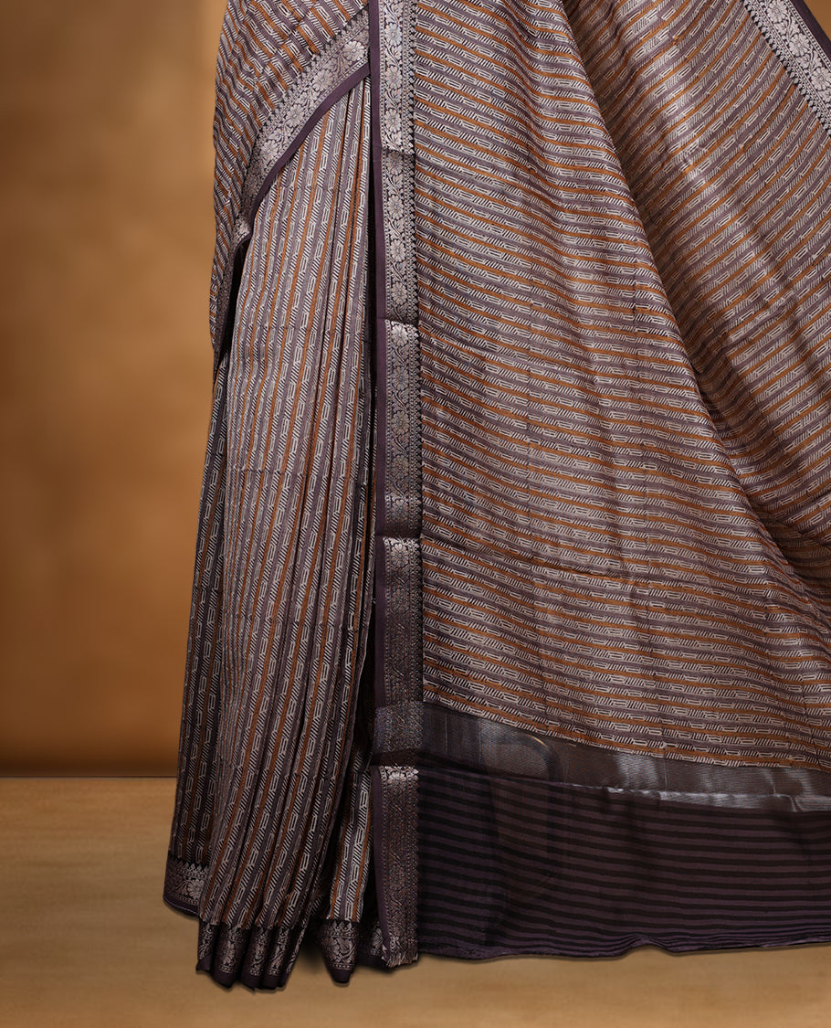 Cream colour chanderi silk saree with purple & yellow geometric stripped printed On body, compilmented by contrast Dark purple colour border with golden zari floral pattern and a matching blouse.