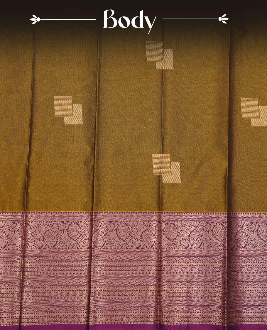 Olive colour soft silk saree featuring Gold zari motifs on body, complemented by contrast purple colour with traditional border, paired with matching blouse piece.