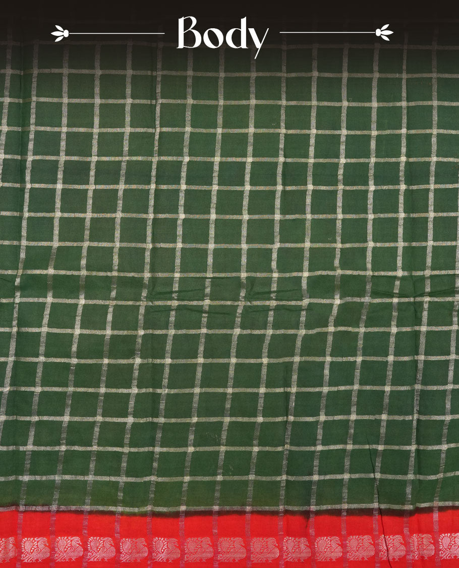 Bottle green colour chettinad cotton saree with silver zari checkered pattern on the body, paired with a contrast red colour pallu featuring silver zari floral border, and a coordinated red checkered blouse piece with matching silver zari border.