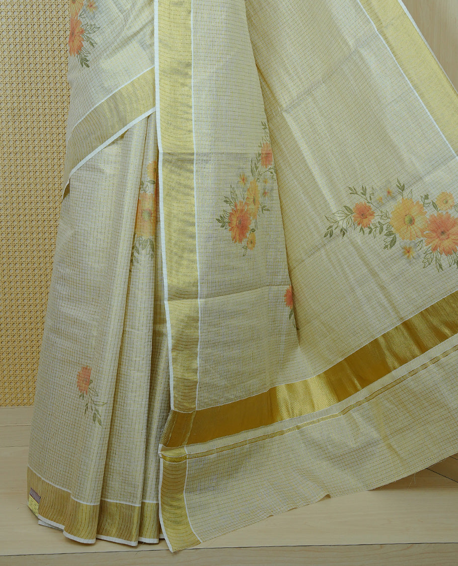 Light gold colour tissue Kerala saree featuring Floral print & Gold zari check on body, complemented by gold Border, comes with matching blouse piece.