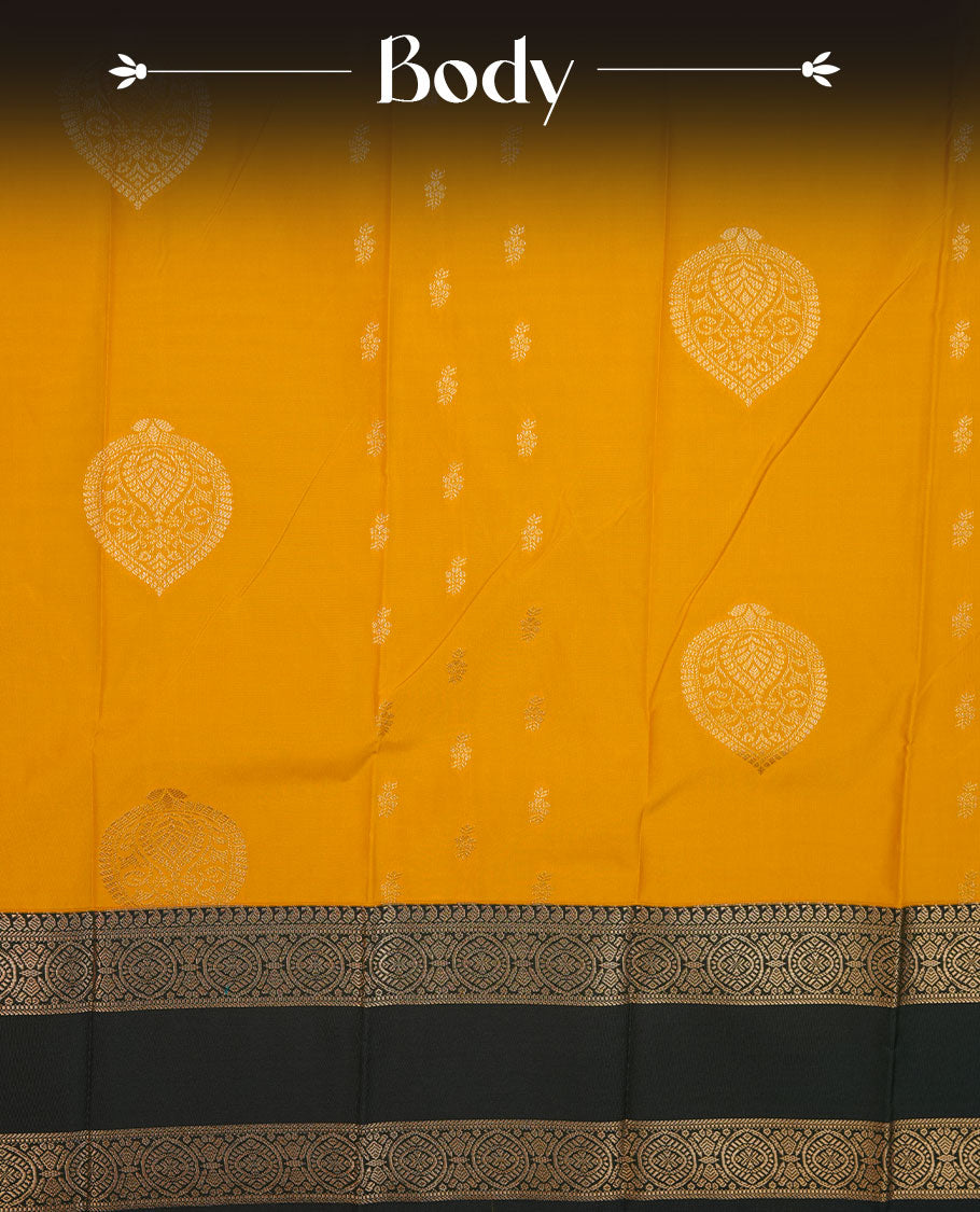Mustrad yellow colour semi silk saree highlighting gold zari motifs across body, featuring contrast Dark green colour border with gold zari pattern, comes with matching blouse.