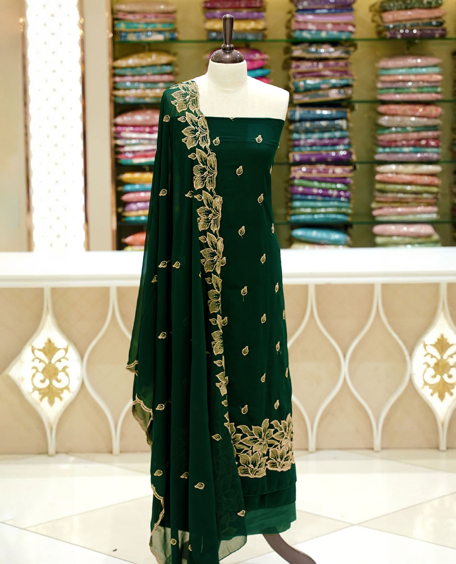Bottle green colour georgette salwar set featuring gold zari buttas on body, floral embroidery and scalp work on dupatta, paired with matching bottom.