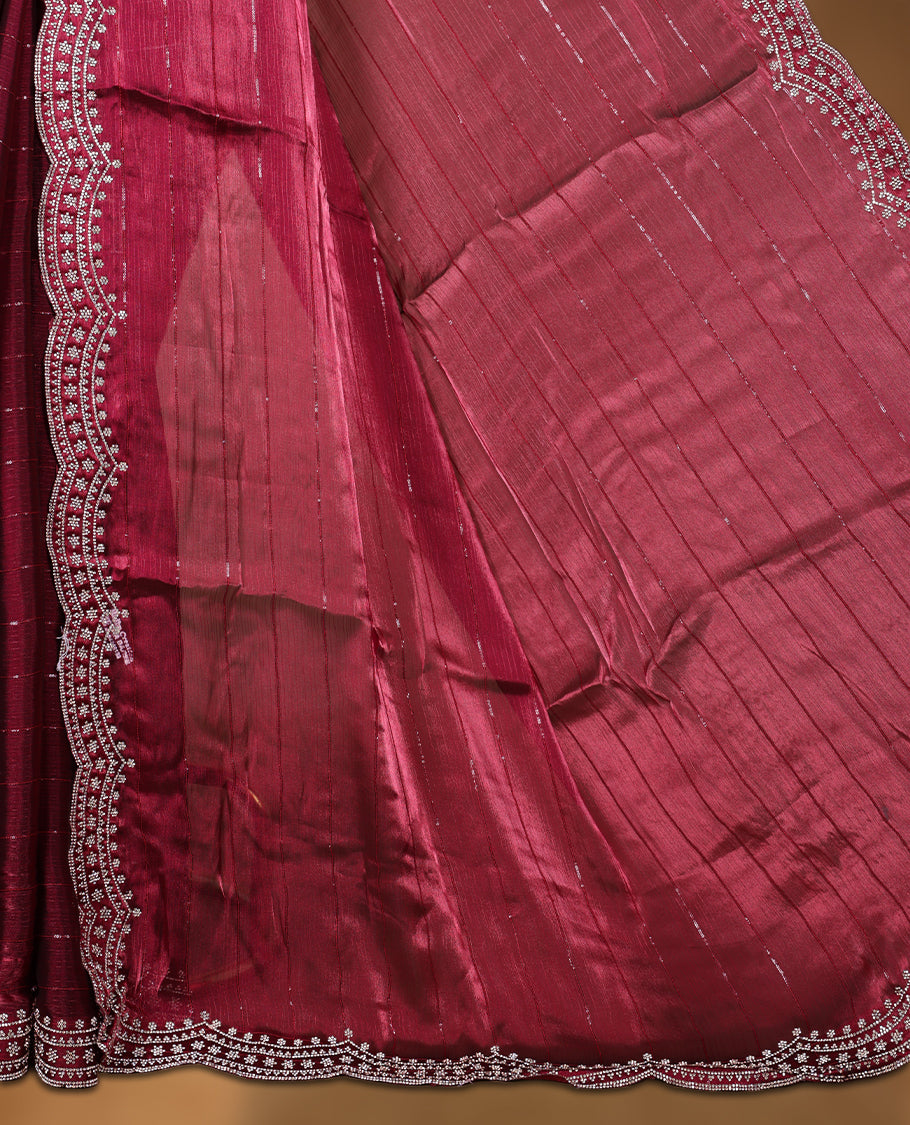 Burgundy colour chiffon designer saree, featuring self colour beats stripes on body, heavy gold stone patttern on border and  pallu, Paired with matching blouse.