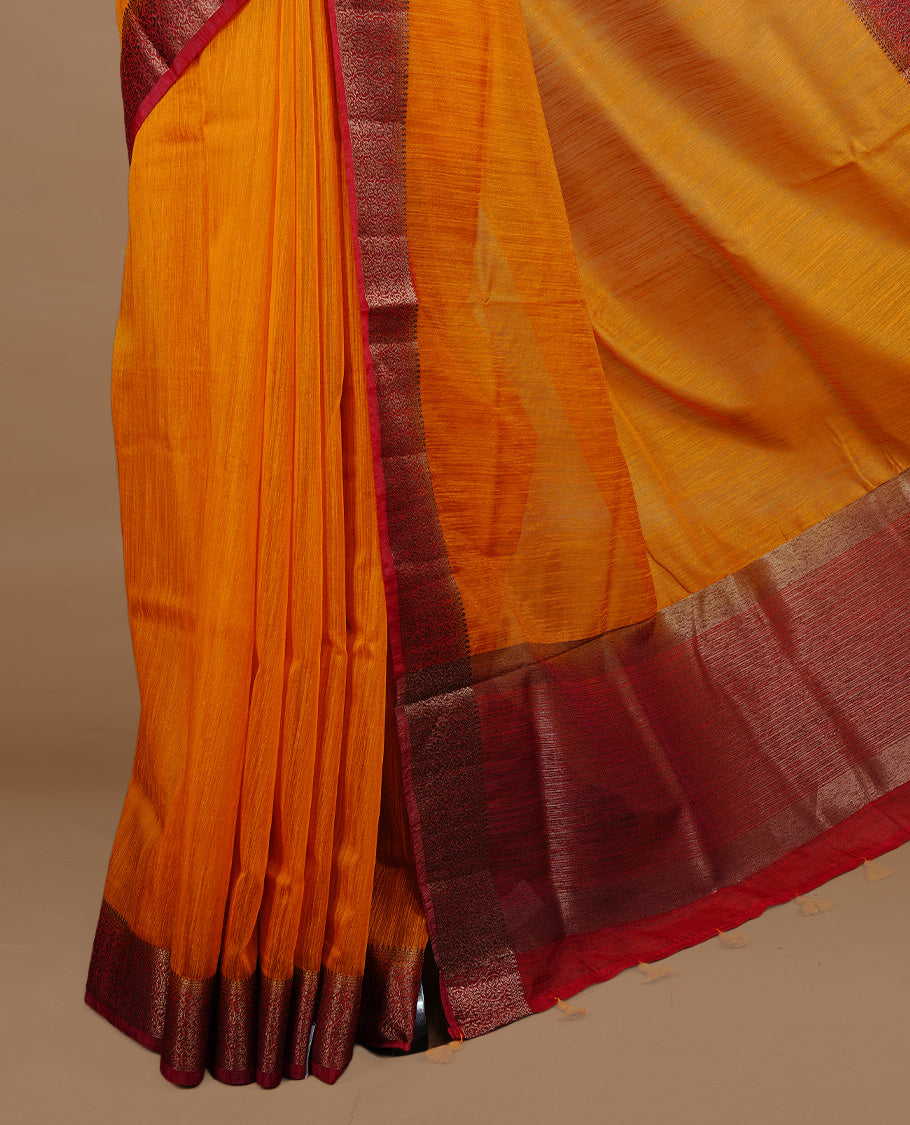 Mustard colour Semi linen saree featuring Elegant plain body, complemented by contrast Maroon colour With Antique zari border, paired with matching blouse piece.